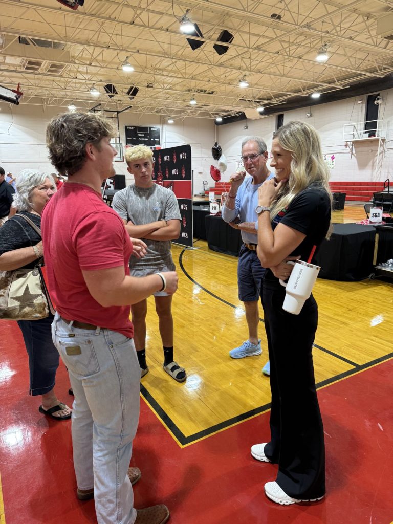Wendi Irlbeck talking with student-athletes and families